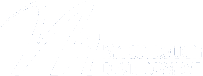Main website logo. White lettering that spells McCullough Development, Inc